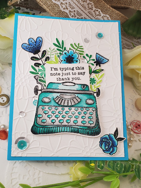 Handmade greeting card featuring a blue typewriter on white embossed card base. The sentiment reads "I'm writing this just to say thank you".