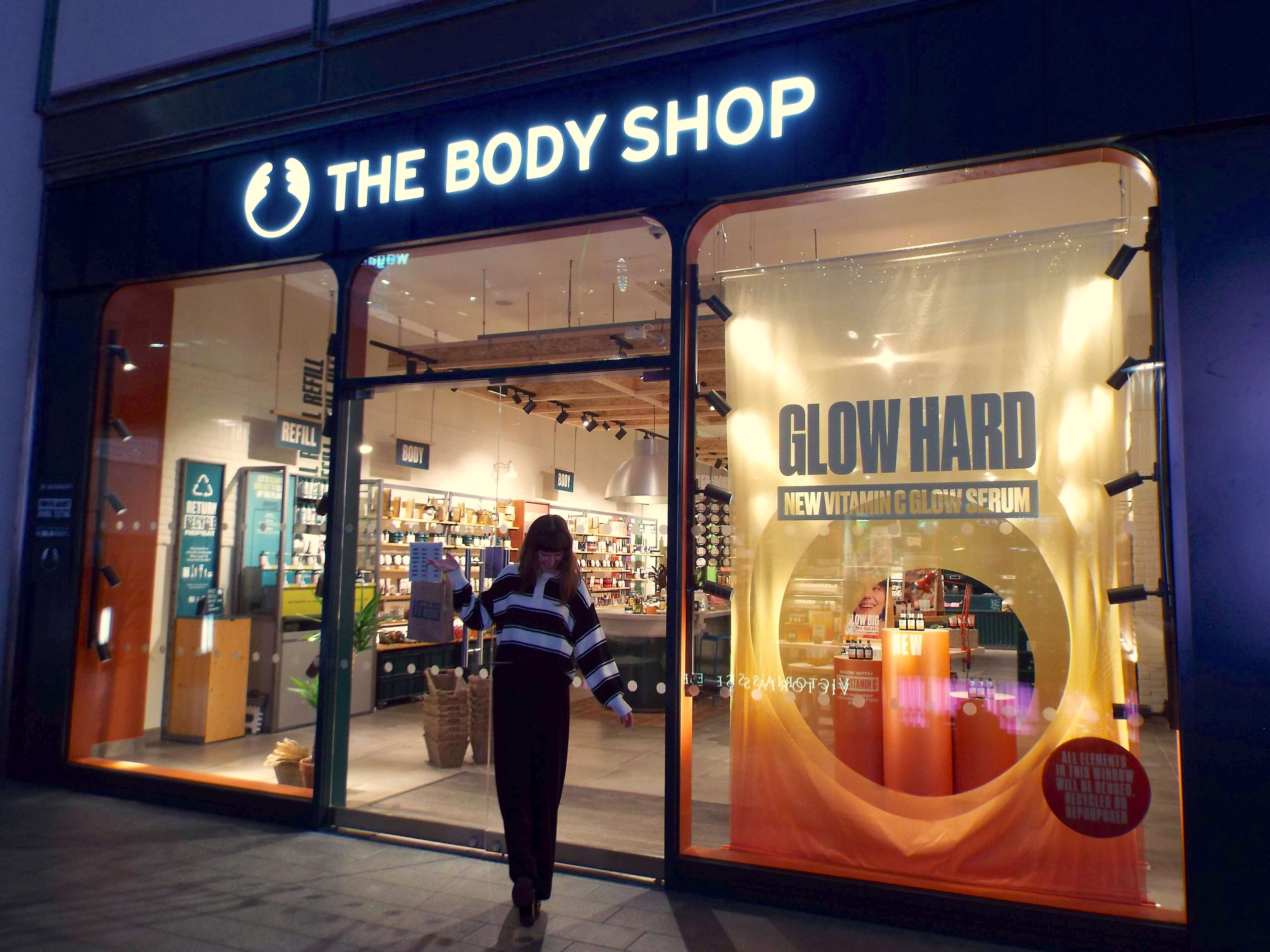 First of the four pictures of me (Ellie) posing outside The Body Shop Liverpool One, holding brown paper bag of goodies.