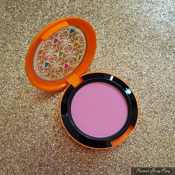 open compact with pink powder blush and orange lid
