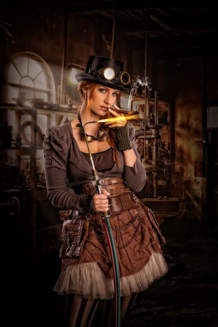 A woman dress in steampunk clothing (goggles, hat, skirt, striped stockings) lighting a cigar with a torch.