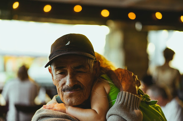 Grandfather holding his grandchild.