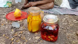 Two closed mason jars filled with vegetables and water, 1 red 1 more yellowish.