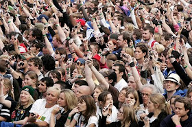 crowd of people holding their cell phone at a convert