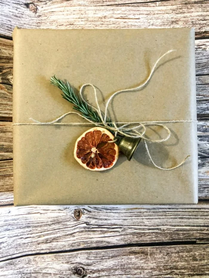 brown paper wrapped gift with dried orange slice
