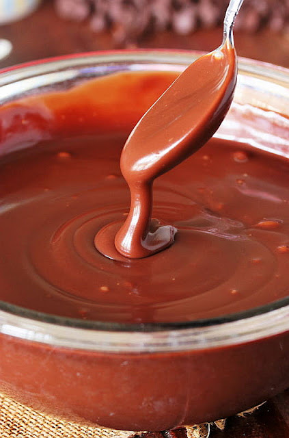 Homemade Chocolate Sauce Dripping from a Spoon Image