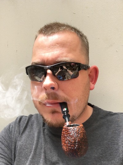 Pipe smoking daddy wearing sunglasses in a gray t-shirt