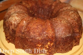 A homemade bundt cake made with bananas and maple with a swirl of nut praline in the center.