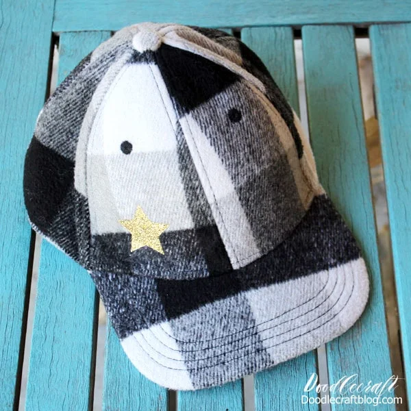 Make a Glitter Star Hat with the new Cricut EasyPress Mini in just 5 minutes. Black and White Buffalo plaid wool ball cap with gold glitter heat transfer vinyl star. Great for doll clothes, sleeves, stuffed animals and more!