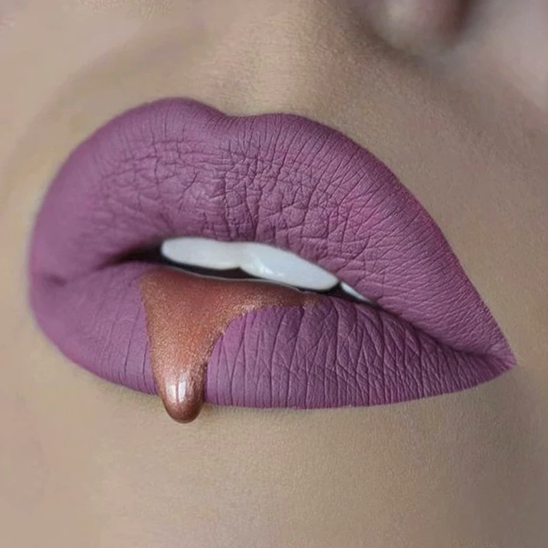mauve woman's lips with dripping gold paint