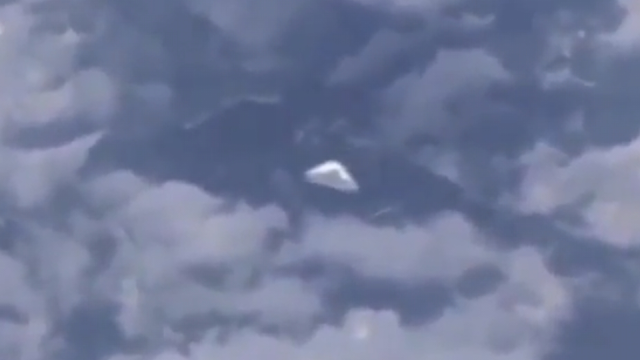 White UFO filmed from a plane.