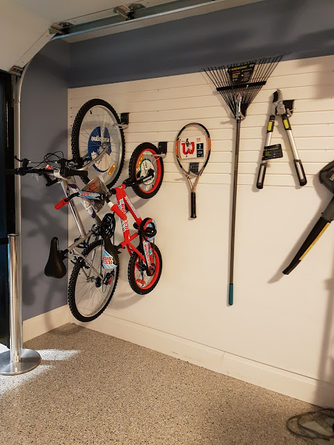 sporting equipment on a garage wall