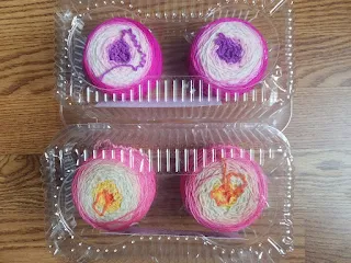 Two sets of gradient sock yarn, each in a cupcake container