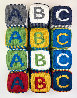 hand knit abc 123 foam blocks in masculine colors, navy blue, gray, white, green, blue, yellow, white, red