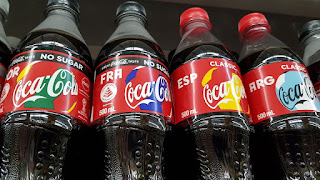 Coca-Cola has labelled some of its bottles with what looks like a football if negative space is considered, together with the three-letter abbreviations for various countries. 