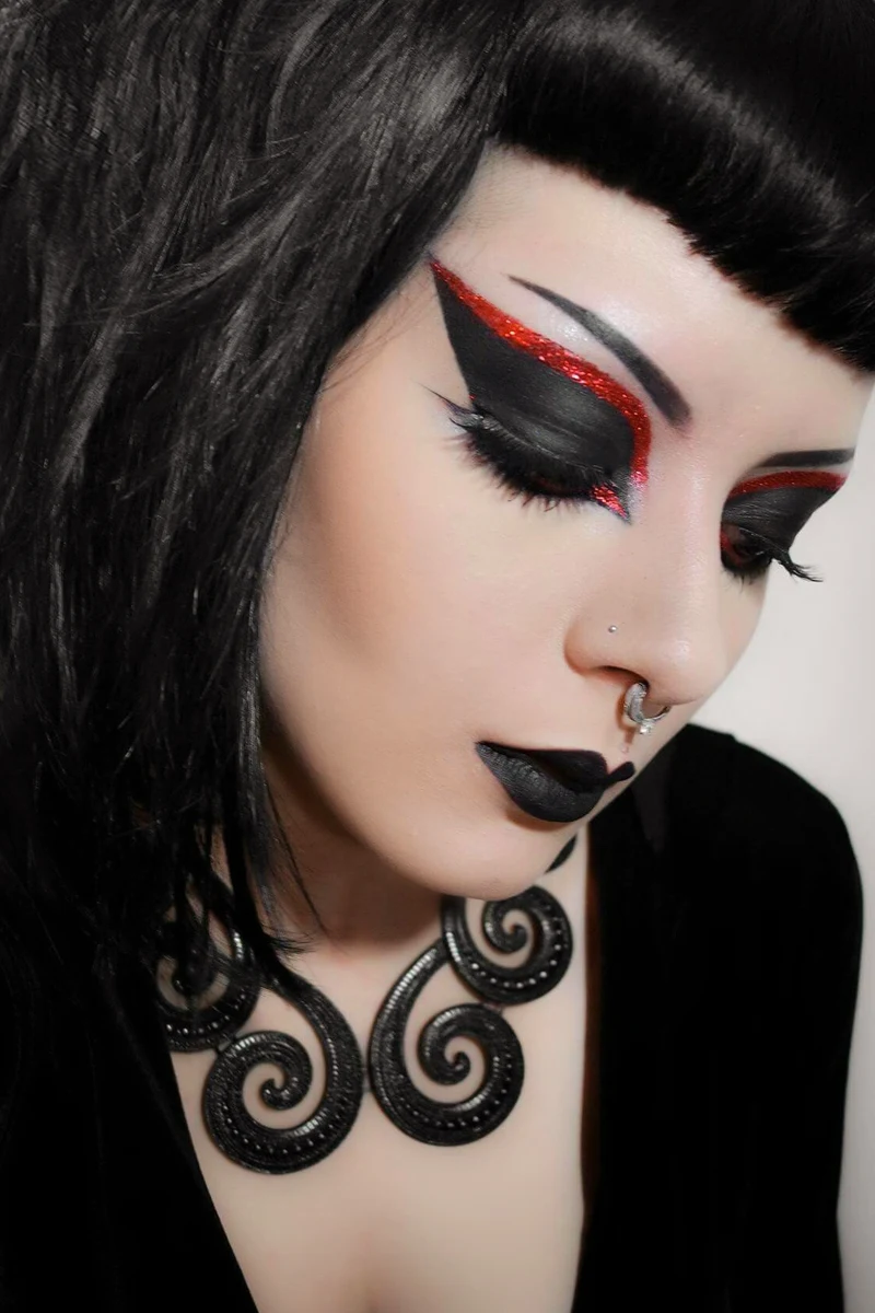 close-up portrait of a young, beautiful woman with goth eyeliner makeup look