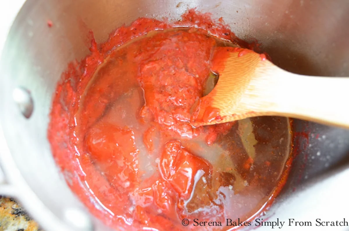 A down shot of Roasted Strawberry Chipotle Barbecue Sauce in a small stainless steel saucepan.