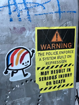 Far away shot of gumdrop sticker and warning sticker in same place