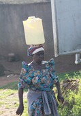 The women wrap a cloth on top of their heads to help balance whatever they're carrying up there. Still, it's amazing how they can balance even top-heavy things, like this gerry can full of water.