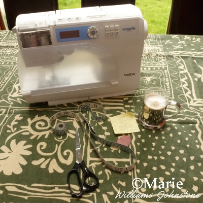 Brother sewing machine, fabric, scissors, tailor's chalk and measuring tape