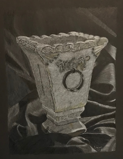 still life drawing of grey pot standing on draped black fabric, Faber-Castell Polychromos pencils on black paper, artist Linzé Brandon