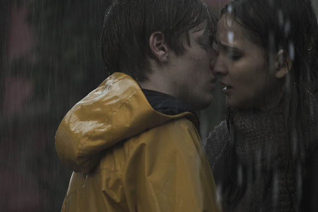 A boy and a girl kiss