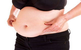 a woman holding her belly flap