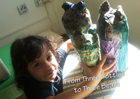 using papier-mache to turn three bottles into three bears