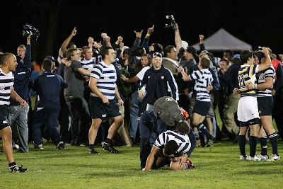 BYU Rugby players and fans swarm together, celebrate the win