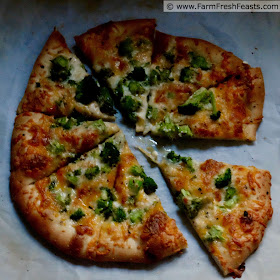 close up image of vegetarian pizza topped with broccoli and 4 cheeses