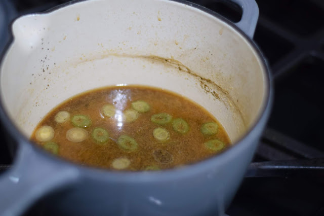 The teriyaki sauce ingredients added to the vegetable broth in the pot, on the stove. 