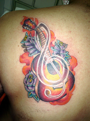 a tattoo depicting him and his famous guitar is a sign of a true fan