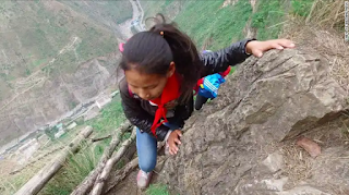 Poor Children Descending a Terrifying Cliff to Attend schhool a picture worth a thousands