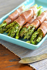 Bundles of asparagus wrapped in prosciutto, creamy goat cheese and a touch of garlic.