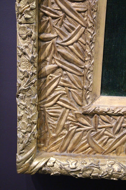 Corner of an elaborately carved Art Nouveau picture frame, gold-gilded wood with floral carving