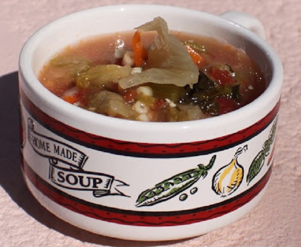 a cup of soup with vegetables all fresh