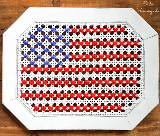 Photo of a flag cross stitched on a can table top.