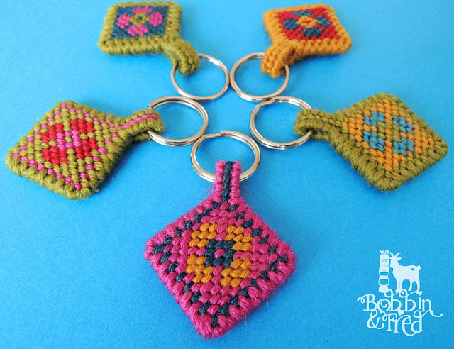 Five needlepoint tapestry keyrings with flower motifs