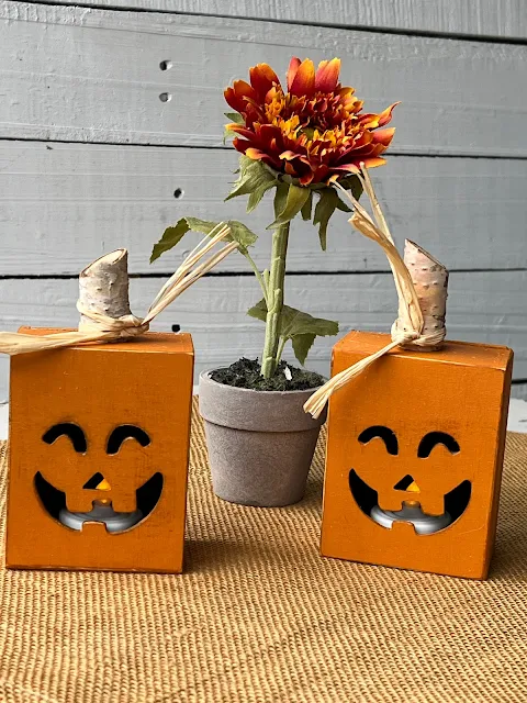 Photo of Dollar Tree painted/upcycled Jack O' Lantern boxes with tealight LED candles.