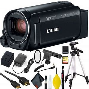 A black canon camcorder and assorted asccessories including tripod, memory card & more.