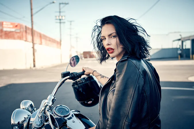 Beautiful Alternative Looking Girl in a  Black Leather Jacket on a Harley Davidson Motorcycle