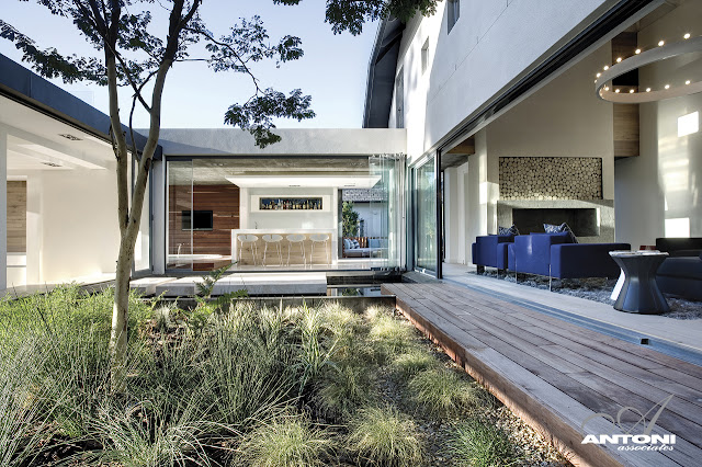 Picture of the modern kitchen and living room as seen from the central backyard