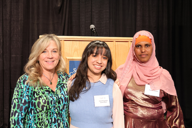 President Huftalin next to two female student