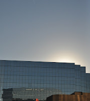 photo of sun setting behind office building