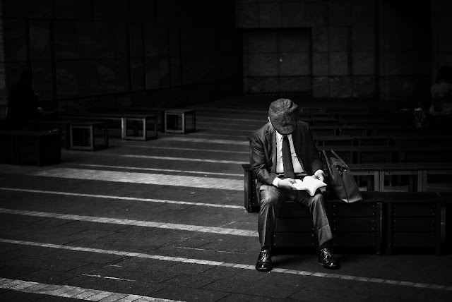 man in dark reading at library