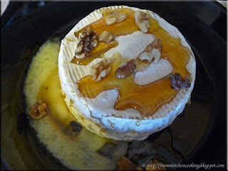 baked brie topped with honey and walnuts