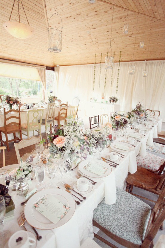  blush toned flowers neutral table cloth mismatched wood chairs