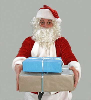 man dressed as santa claus presents gifts