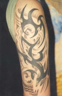 Whole hand tattoo with tribal signs