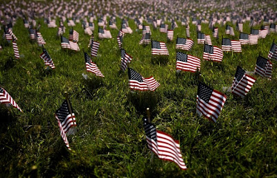 Exactly 2,977 American flags line the lawn of the Strategic Air and Space Museum and each flag has a name, age of the victims of the Sept. 11, 2001, attacks.
