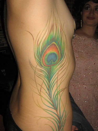 Peacock Tattoos glance at the woman